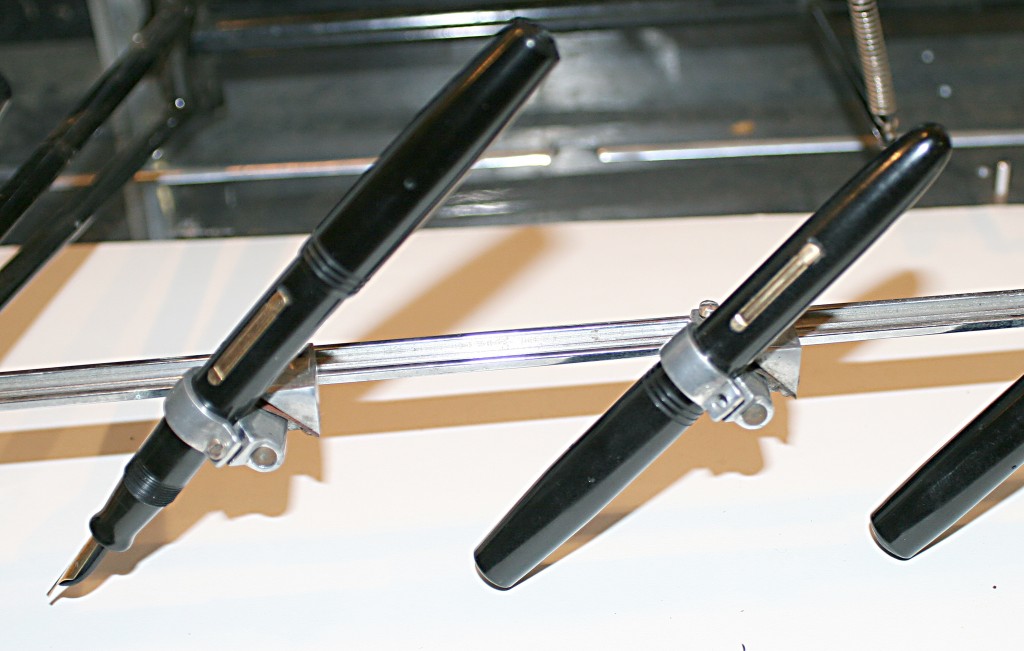 A close up of fountain pens mounted in a Signagraph.